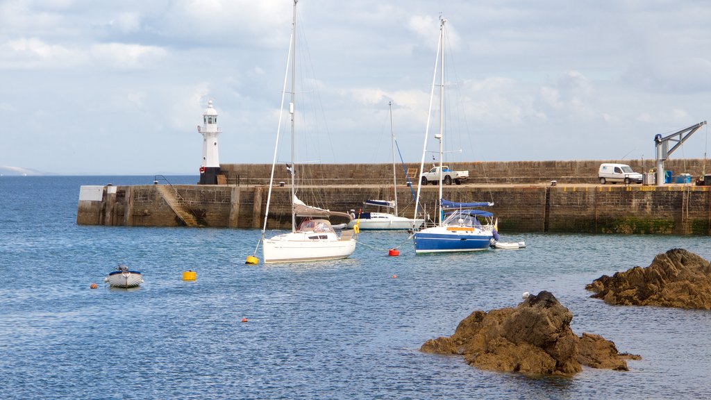 Mevagissey showing rugged coastline, a lighthouse and boating