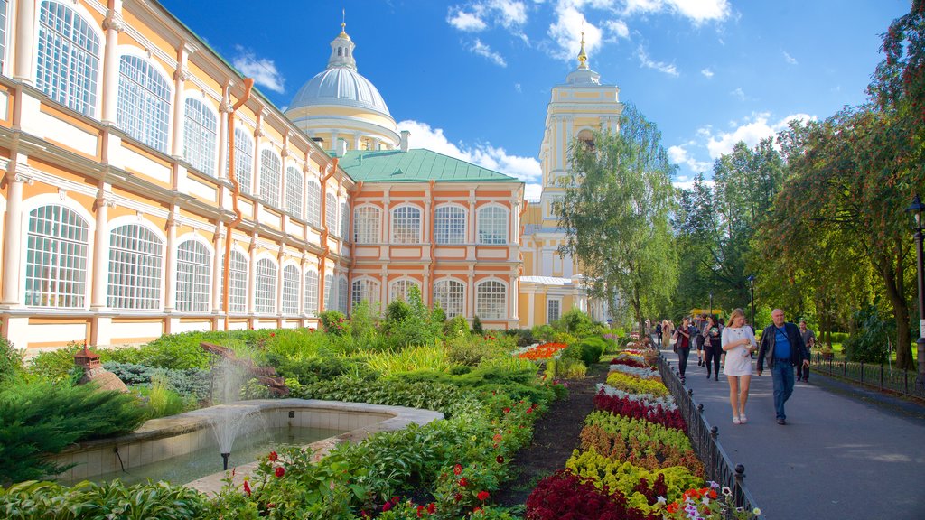 Alexander Nevsky Lavra showing a garden and heritage architecture as well as a small group of people