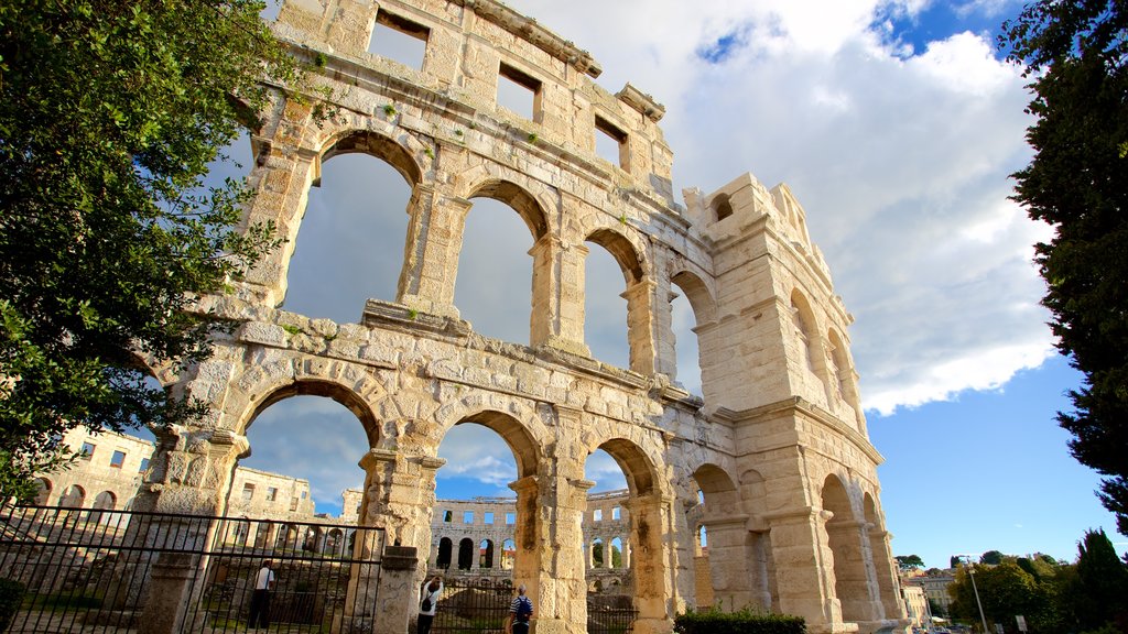 Pula Arena showing building ruins, a monument and heritage architecture