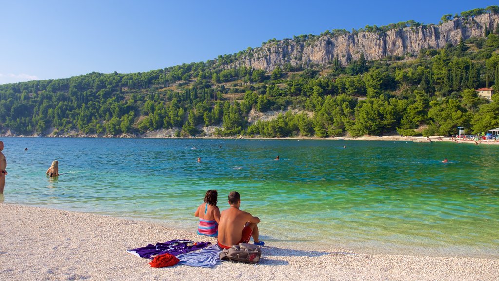 Playa de Kasuni que incluye una playa y vistas generales de la costa y también una pareja