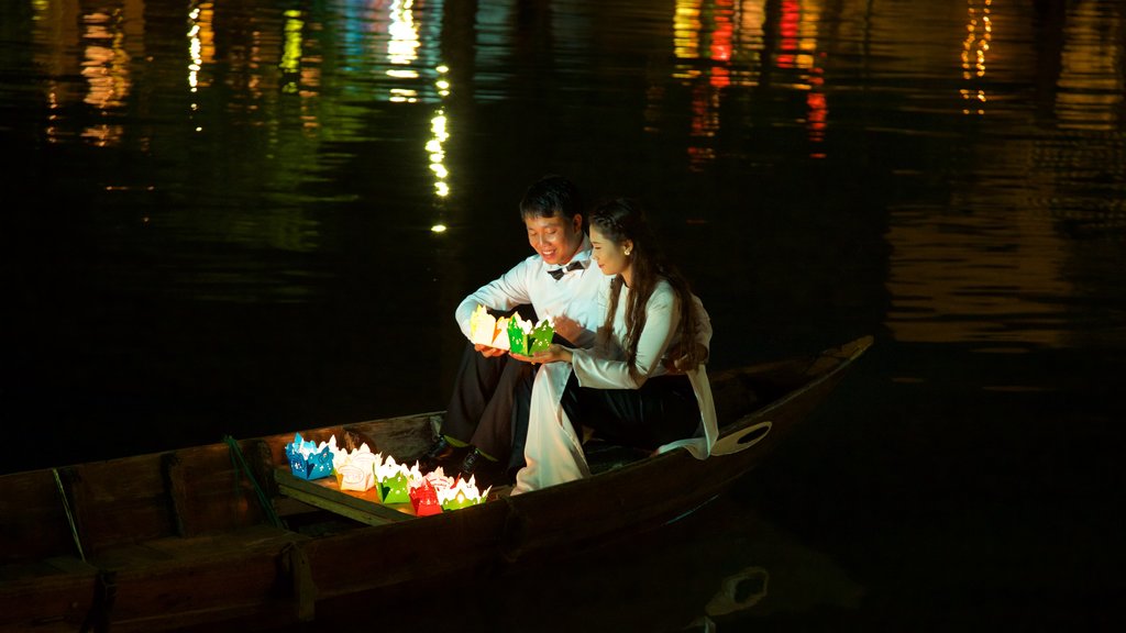 Hoi An featuring night scenes and kayaking or canoeing as well as a couple