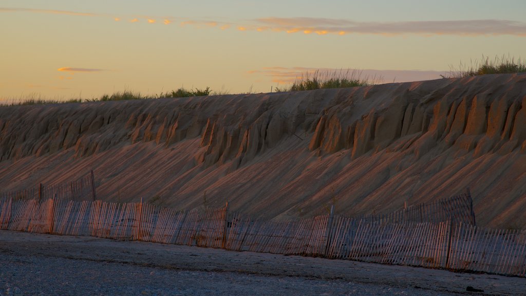 Sandy Neck Beach which includes general coastal views and a sunset