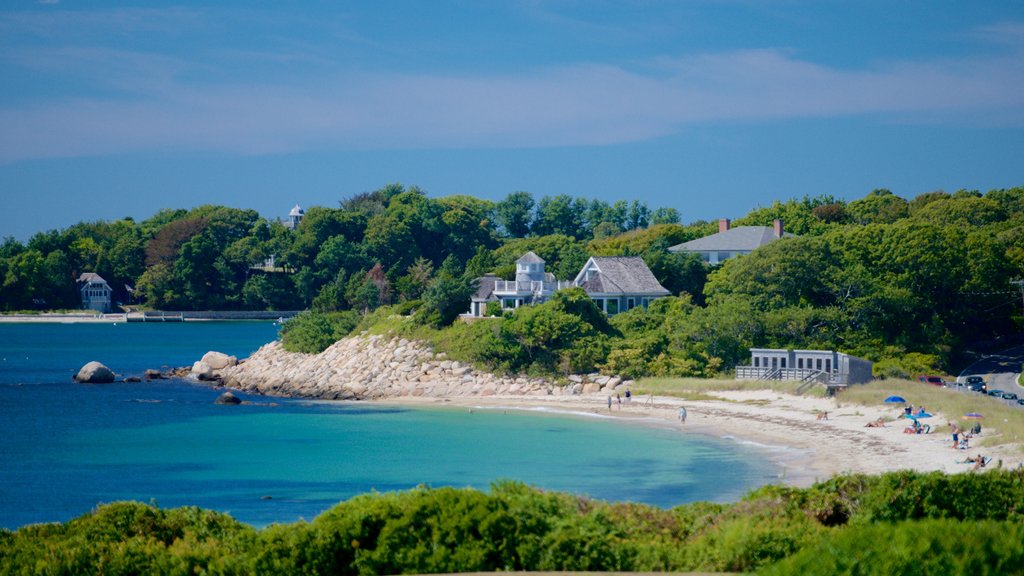 Nobska Lighthouse showing a sandy beach, a house and rugged coastline