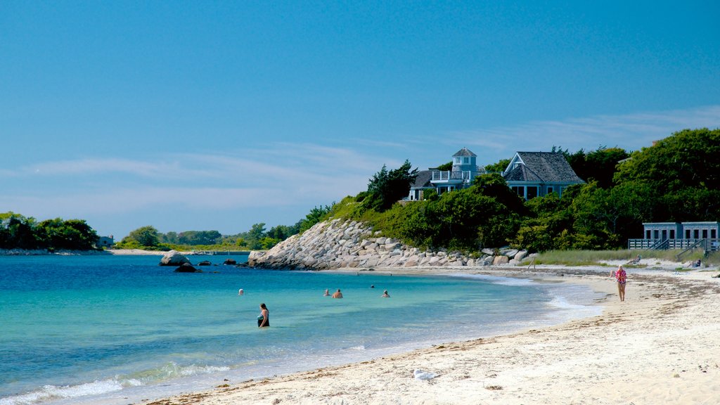 Nobska Lighthouse featuring rugged coastline, a sandy beach and swimming