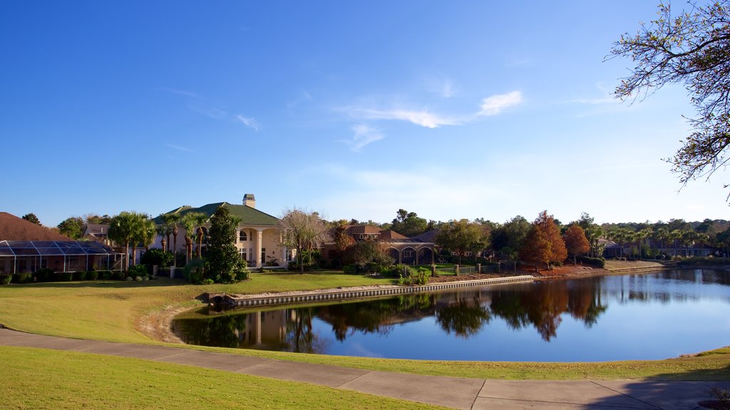 Upper Grand Lagoon which includes a lake or waterhole and a house