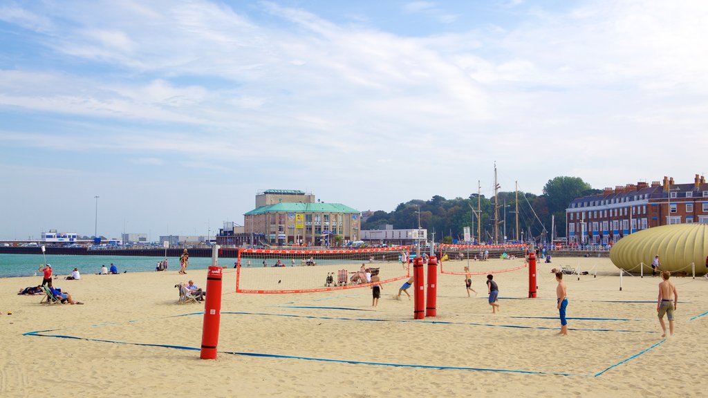 Weymouth Beach showing a sporting event and a sandy beach as well as a small group of people