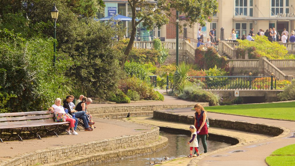 Bournemouth Lower Gardens featuring a river or creek and a park as well as a family