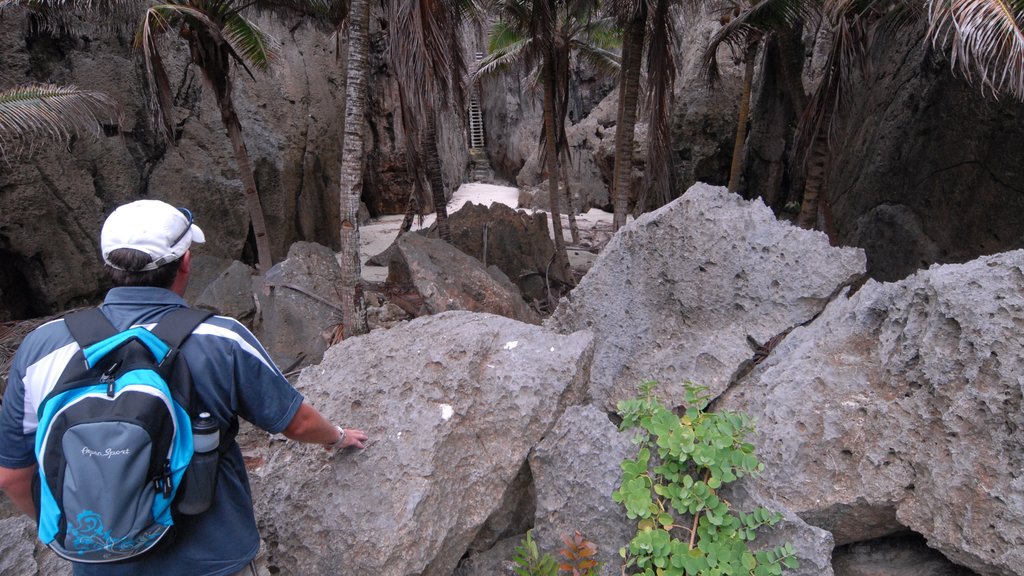 Togo Chasm featuring hiking or walking and a gorge or canyon as well as an individual male