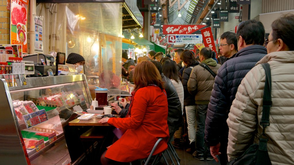 Satsumasendai showing shopping as well as a large group of people