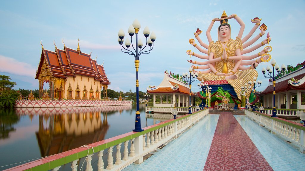 Wat Plai Laem mostrando una estatua o escultura, elementos religiosos y un templo o lugar de culto