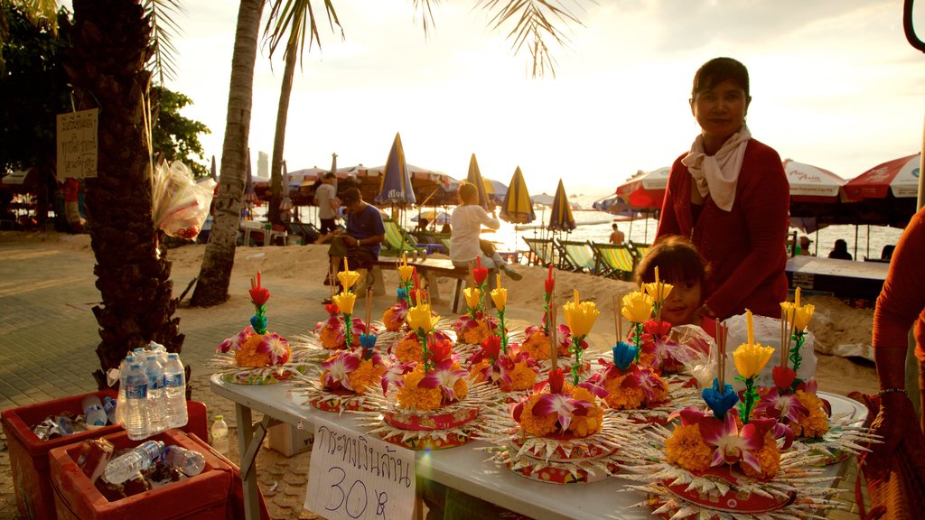 Pattaya Beach which includes shopping and a sunset as well as a small group of people