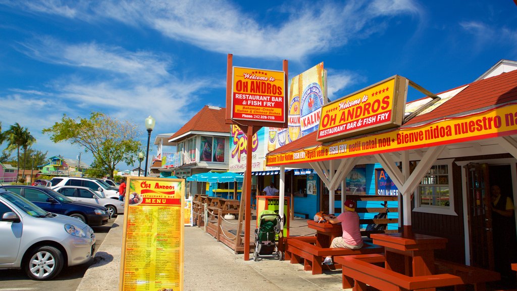 Arawak Cay featuring shopping and street scenes as well as a small group of people