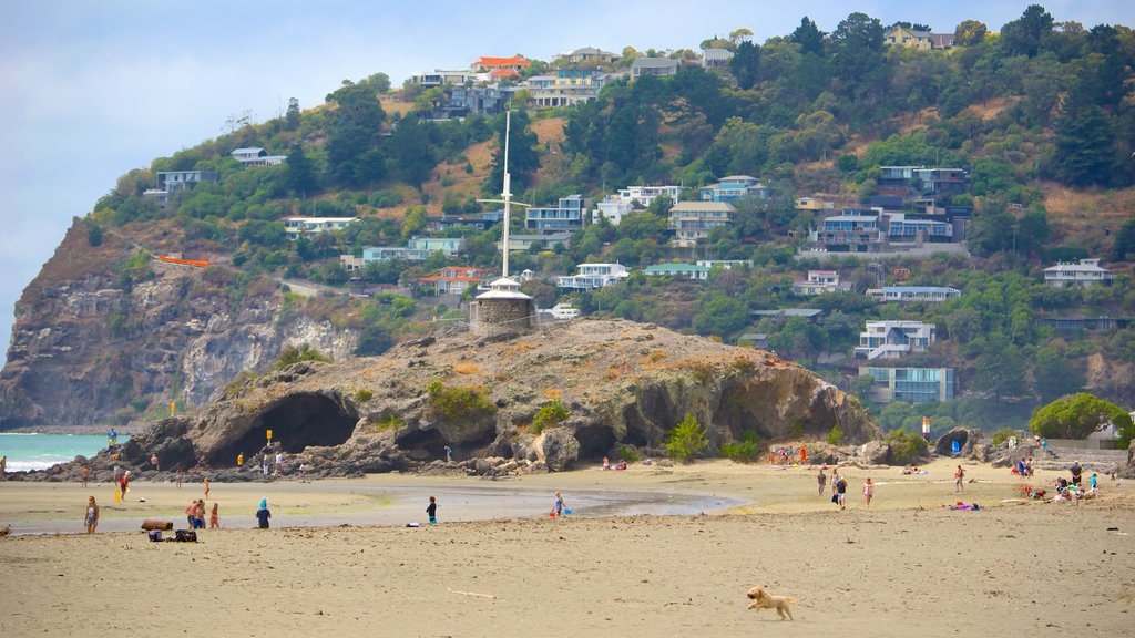 Cave Rock featuring a coastal town, caves and a beach