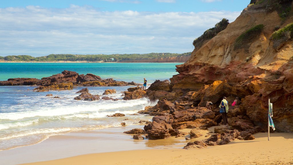 Anglesea showing a sandy beach and rocky coastline