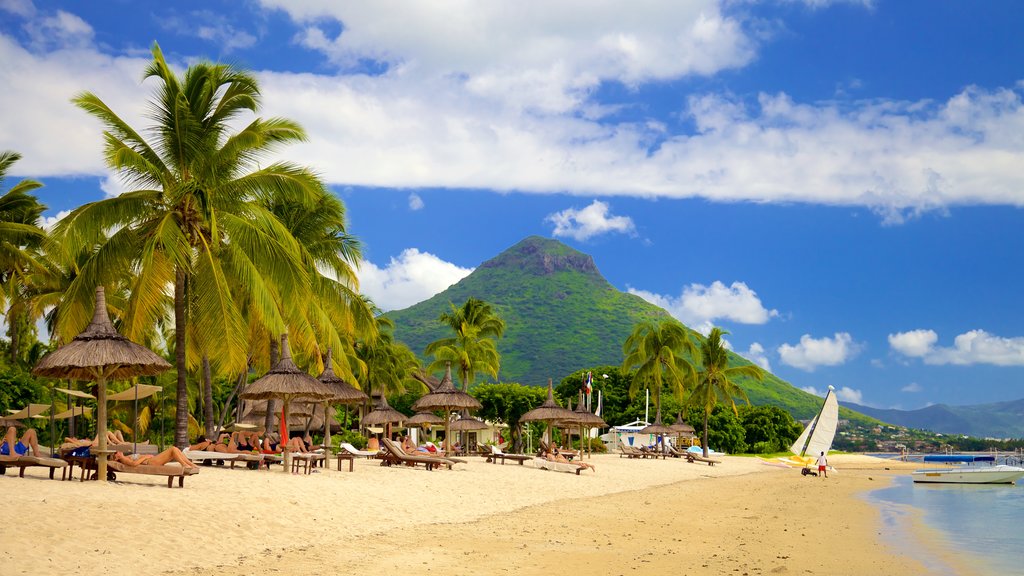 Flic-en-Flac showing a luxury hotel or resort, a sandy beach and mountains