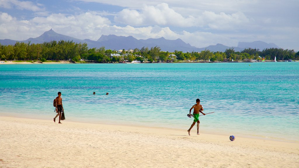 Pieter Both Mountain featuring a sandy beach as well as a small group of people