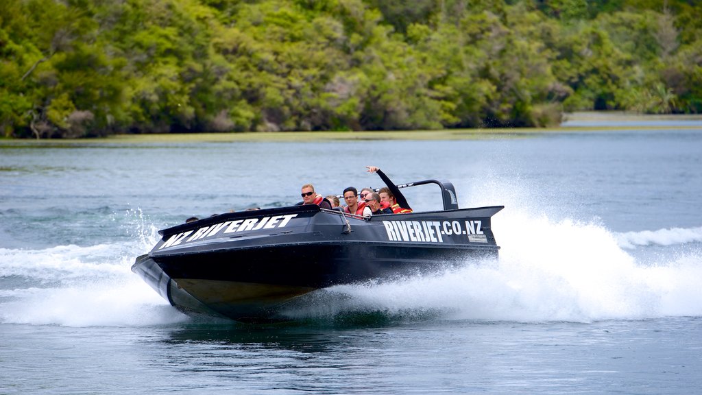 Orakei Korako Geothermal Park and Cave featuring boating as well as a small group of people