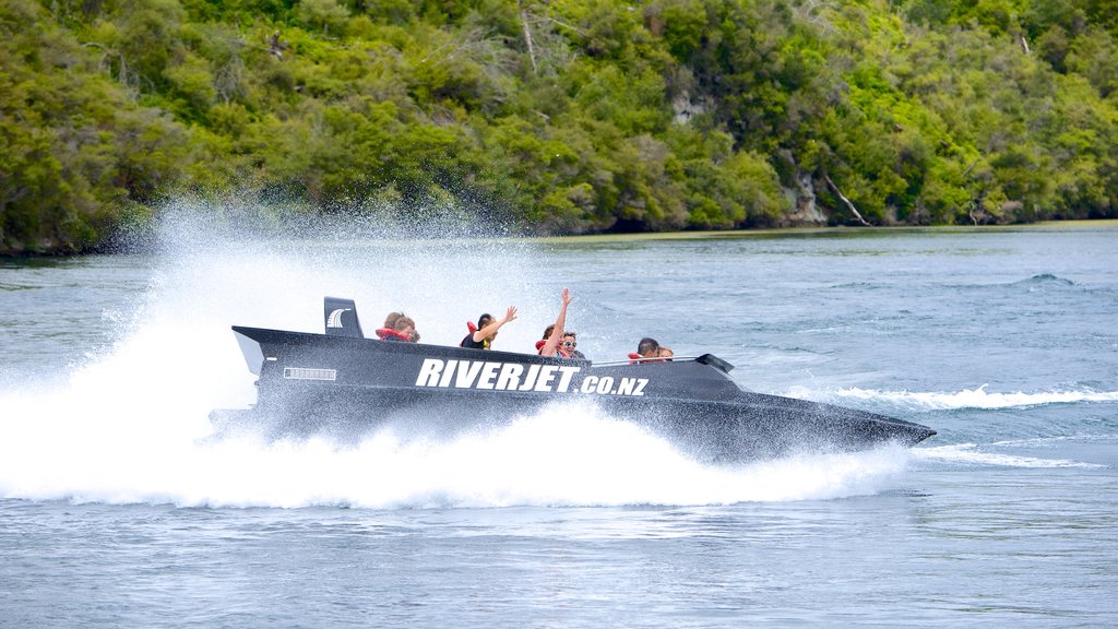 Orakei Korako Geothermal Park and Cave showing boating as well as a small group of people