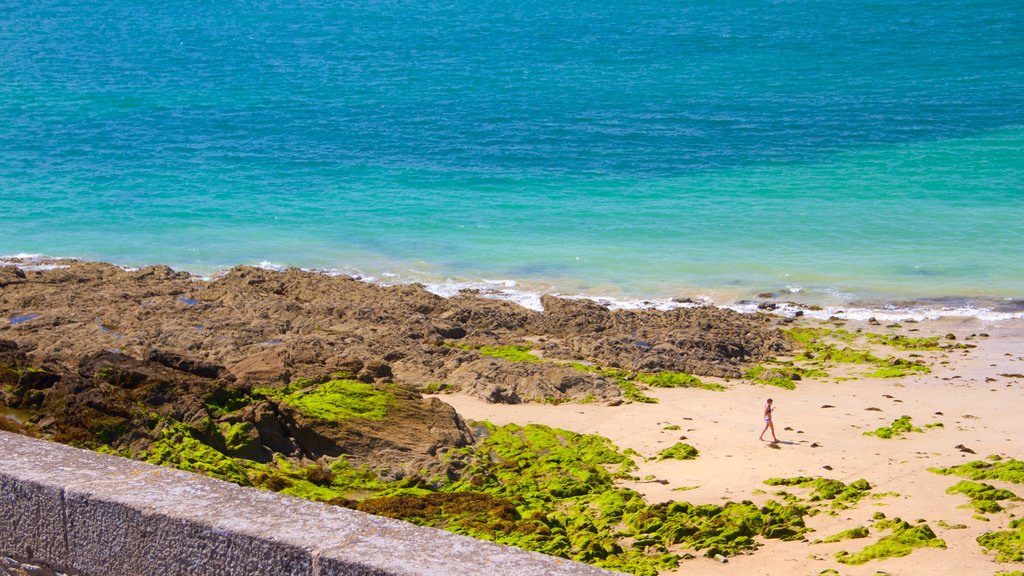 St. Malo Beach which includes a sandy beach, rugged coastline and general coastal views