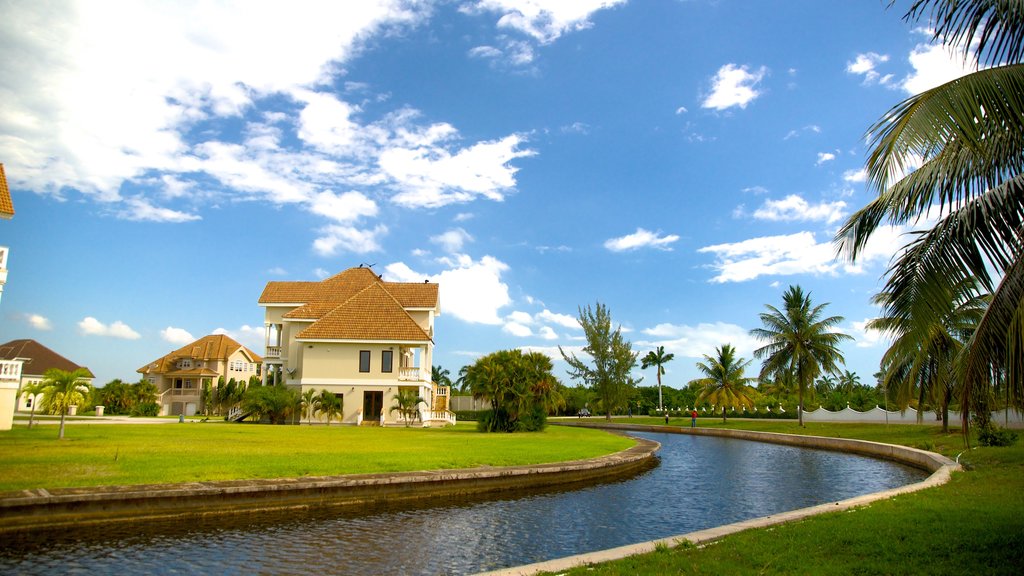 Placencia Beach which includes a house and a river or creek