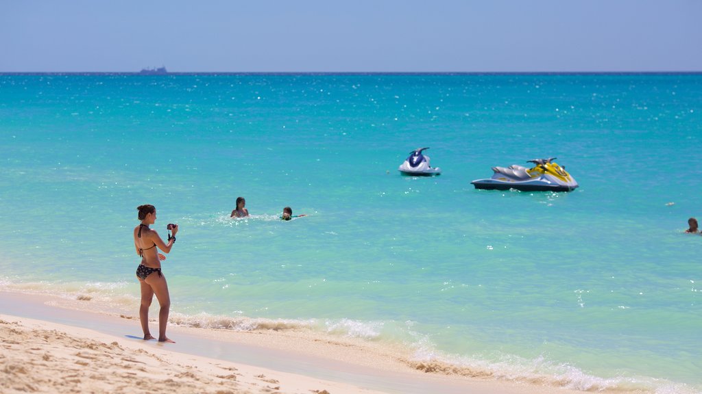 Eagle Beach featuring a sandy beach as well as an individual female