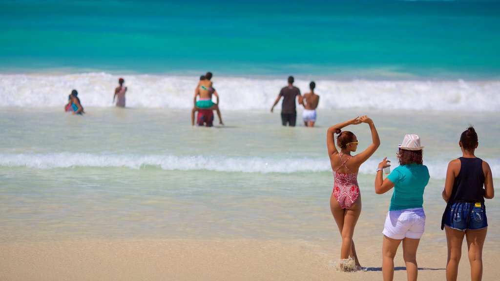 Macao Beach showing a sandy beach as well as a small group of people