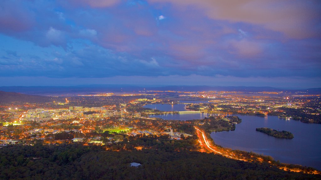 Telstra Tower showing a city, a lake or waterhole and night scenes