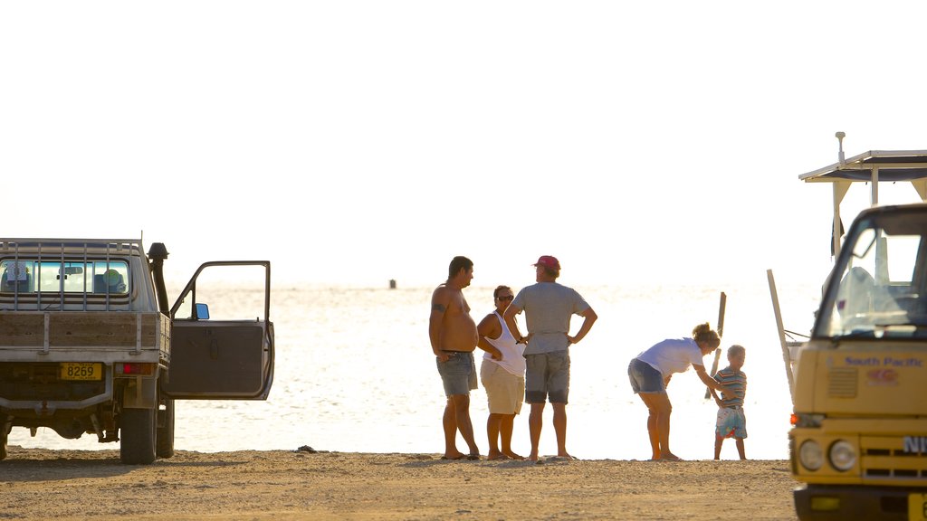 Arutanga featuring general coastal views as well as a small group of people