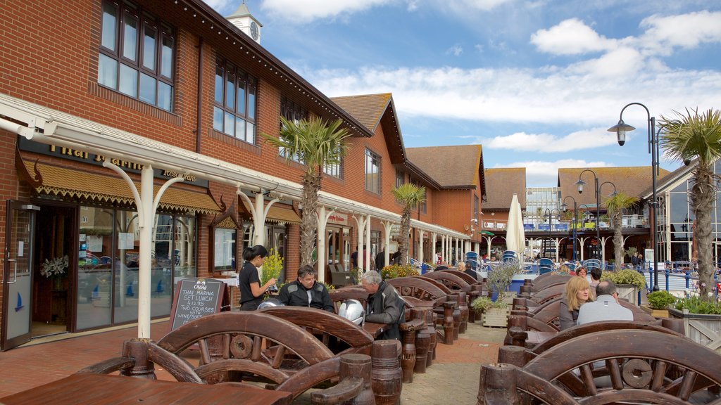 Sovereign Harbour featuring outdoor eating as well as a small group of people