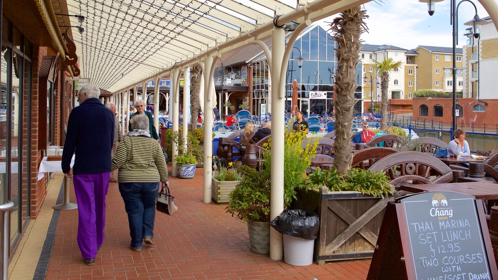 Sovereign Harbour showing outdoor eating and signage as well as a couple