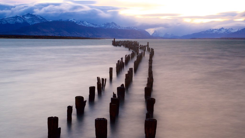 Puerto Natales which includes a sunset, landscape views and a lake or waterhole