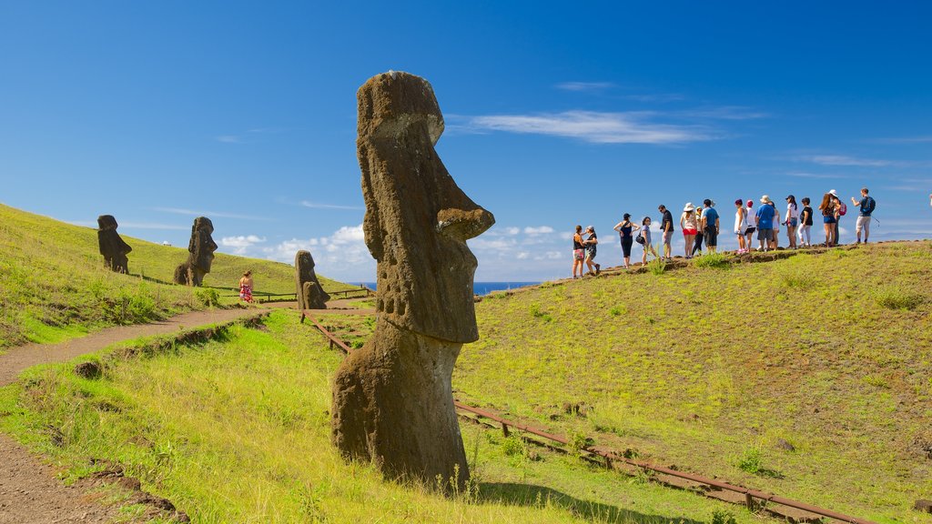 Rano Raraku which includes a statue or sculpture and heritage elements as well as a small group of people