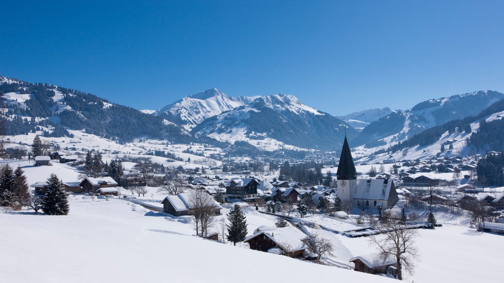 Gstaad showing a small town or village and snow