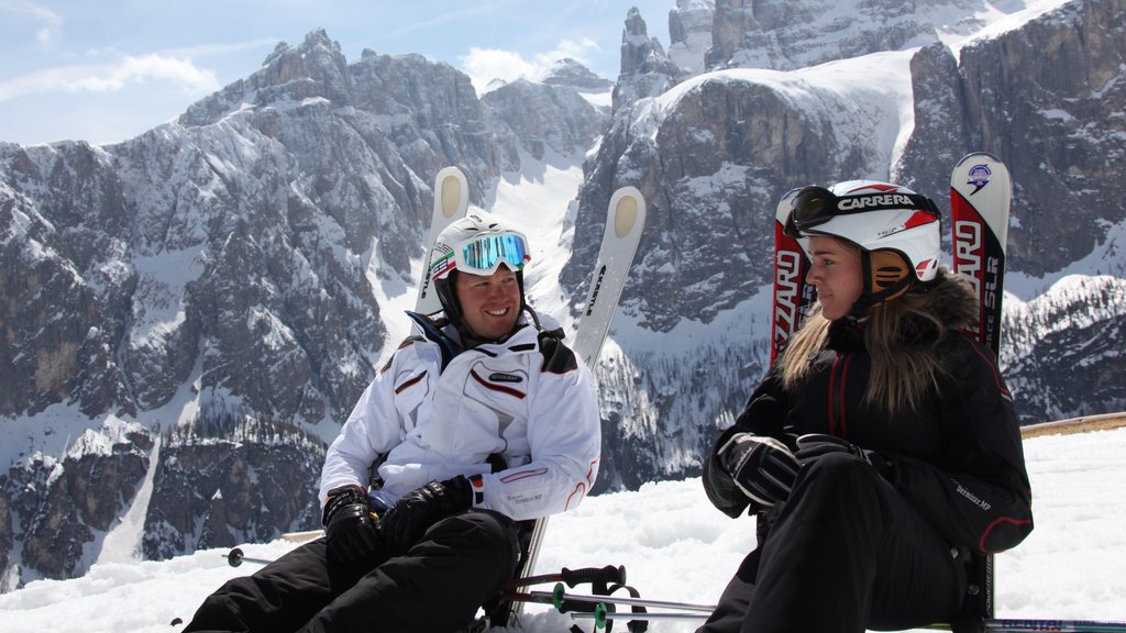 Alta Badia which includes snow and snow skiing as well as a small group of people