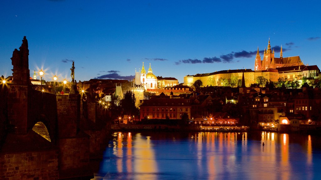 Charles Bridge featuring night scenes, heritage elements and a river or creek