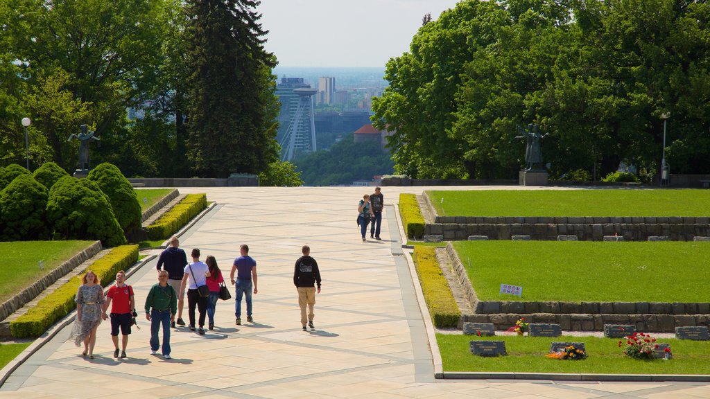 Slavin Monument featuring a cemetery as well as a small group of people