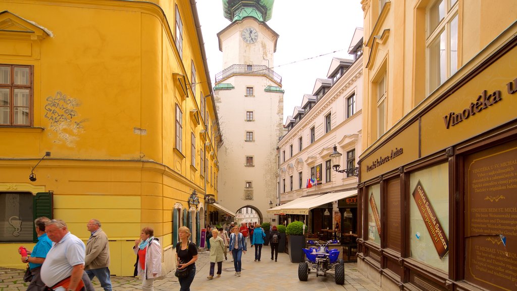 Michael\'s Gate featuring street scenes and a city as well as a small group of people