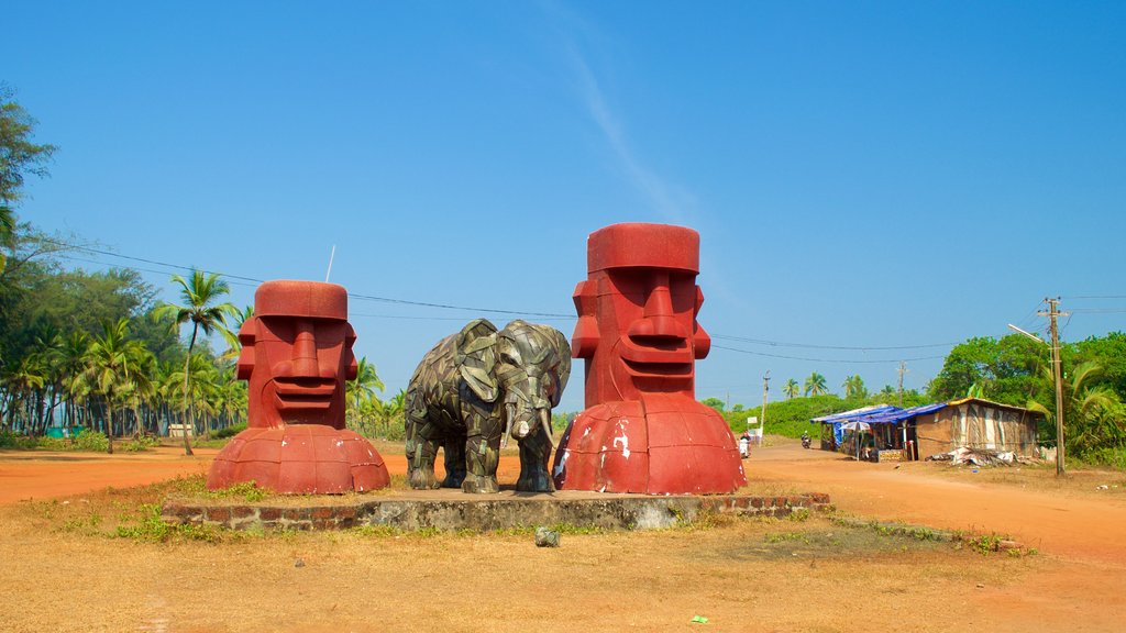 Querim Beach showing farmland, a small town or village and a statue or sculpture