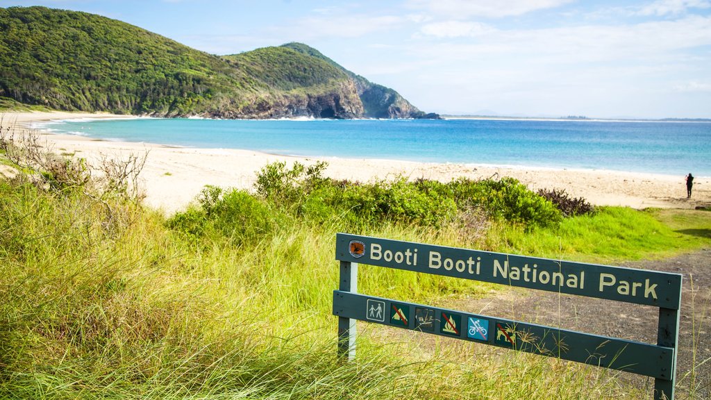 Forster showing mountains, signage and a sandy beach