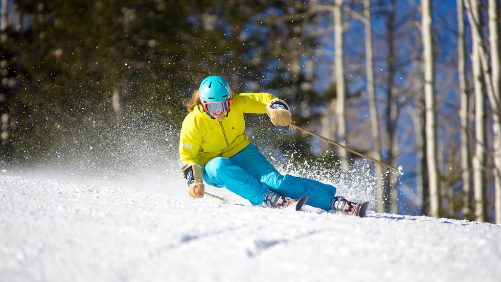 Canyons Village at Park City featuring snow skiing and snow as well as an individual female