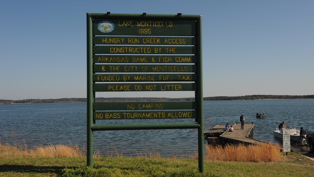 Monticello showing a lake or waterhole and signage