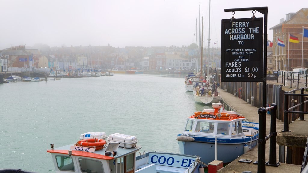 Weymouth showing a river or creek, mist or fog and signage