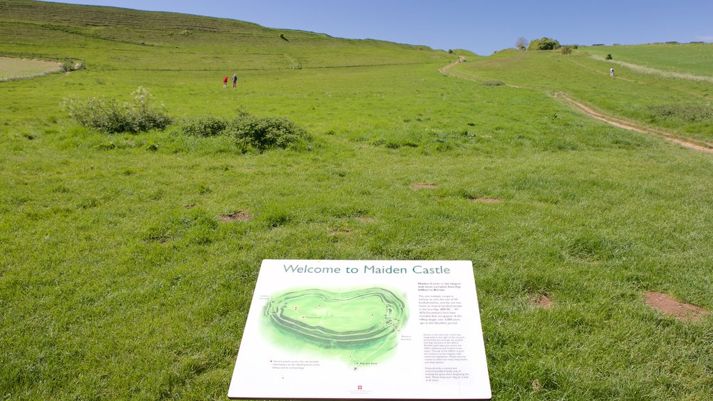 Maiden Castle which includes signage and tranquil scenes