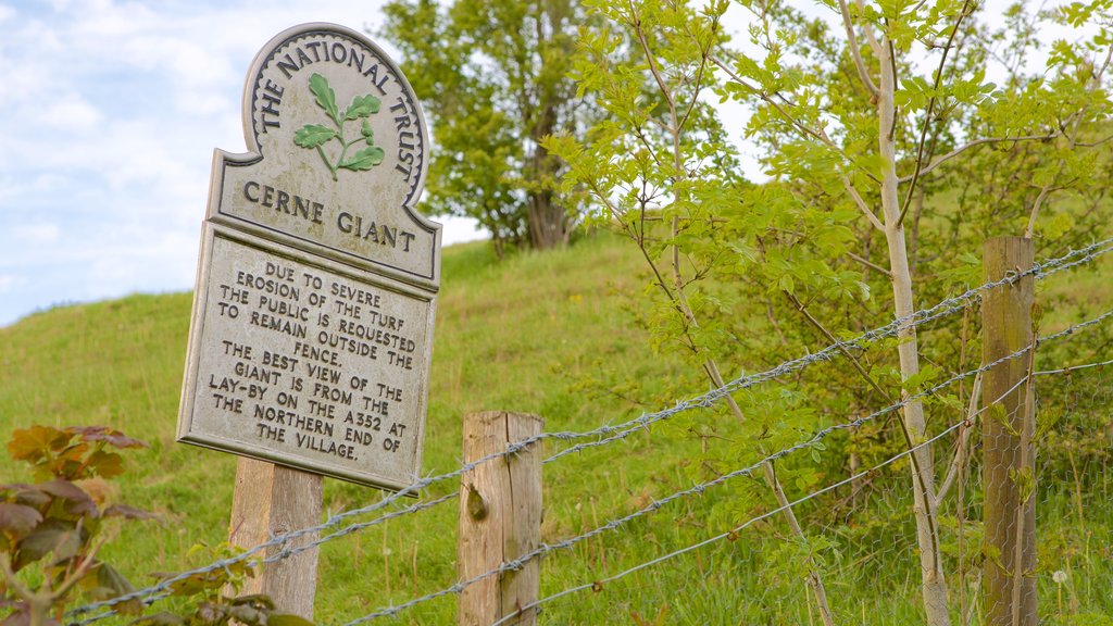 Cerne Abbas Giant which includes signage and tranquil scenes