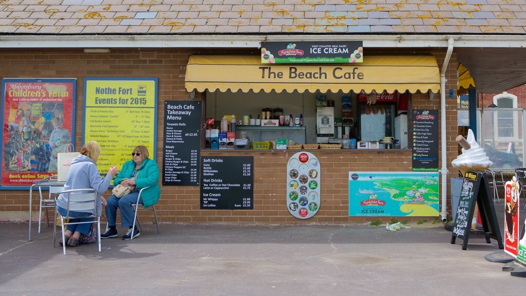 Playa de Weymouth mostrando comidas al aire libre, escenas de café y señalización