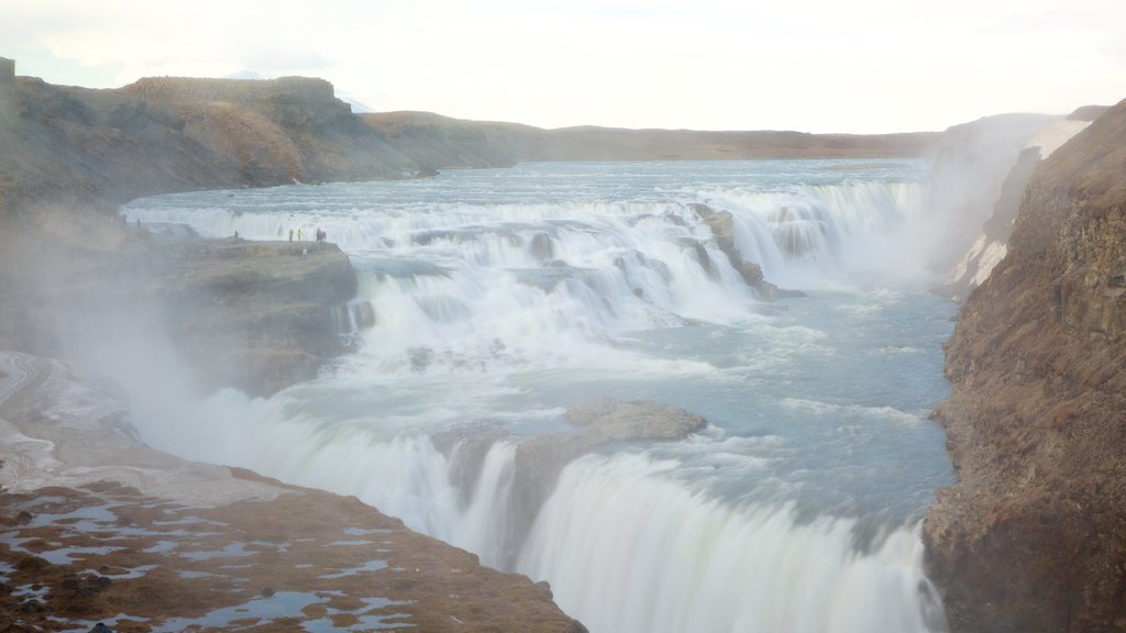 Geysir Hot Springs which includes a waterfall, mist or fog and a gorge or canyon