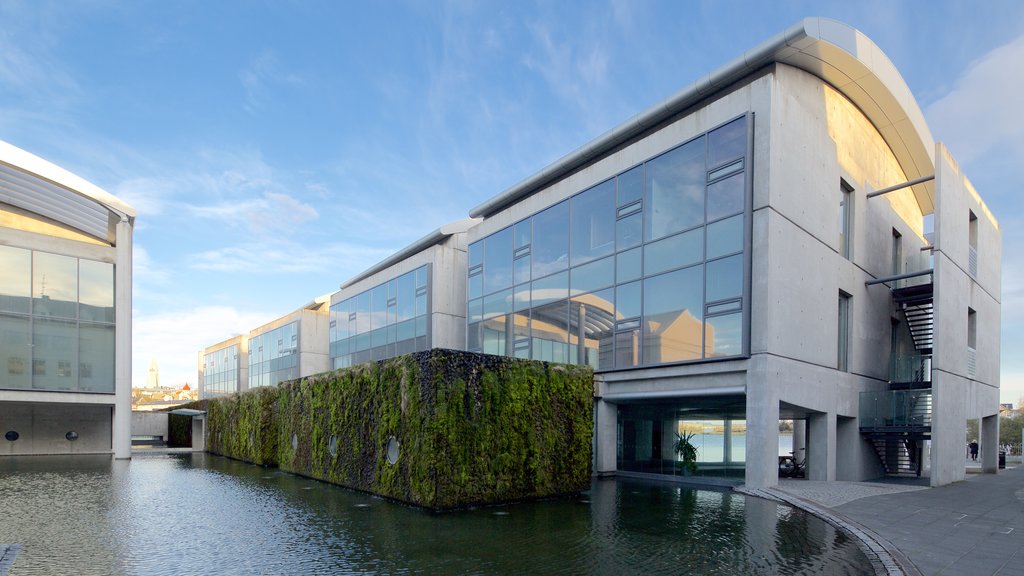 Reykjavik City Hall featuring a pond and modern architecture