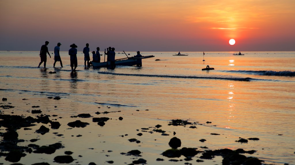 Oslob Beach which includes a sunset, general coastal views and a beach