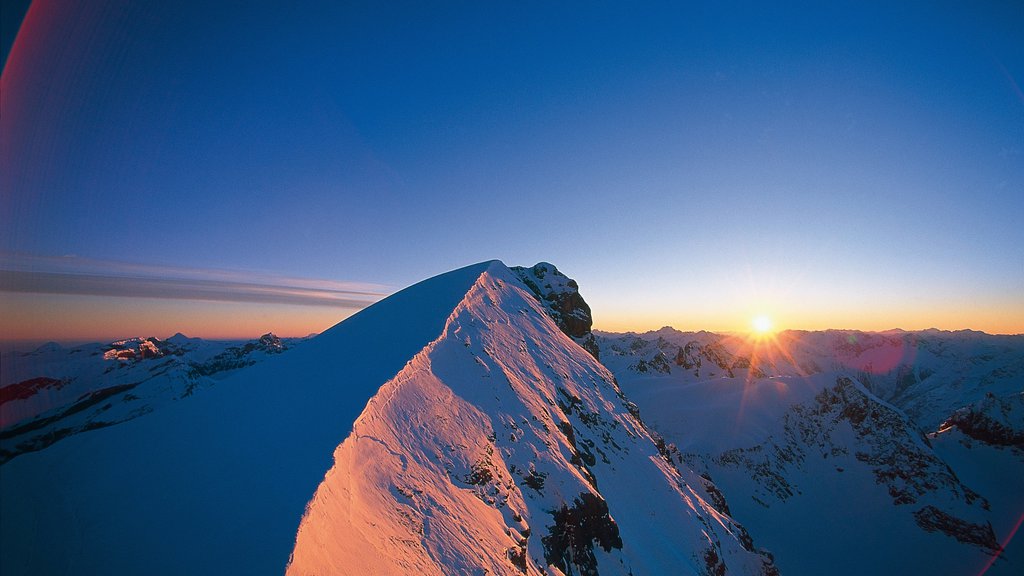 Engelberg-Titlis Ski Resort showing a sunset, snow and mountains