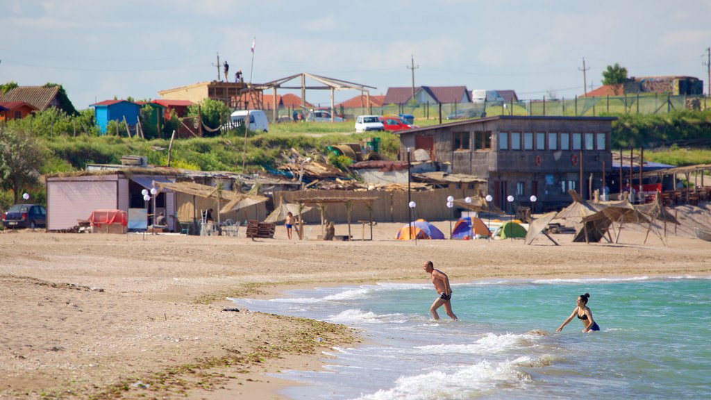 Vama Veche which includes a coastal town and a sandy beach